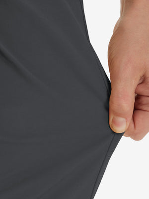 Action shot demonstrating the stretch of the dark grey youth water resistant cotton blend golf pants for active movement