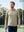 Front upper body angled shot of model wearing  taupe heather heather midlayer golf hoodie, holding a racket in one hand on the court