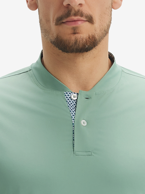 Close-up of model in grey green moisture-wicking short sleeve henley shirt, nose to chest front view.
