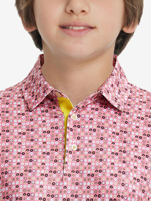 Front view of youth wearing pink donut performance print boys golf polo, showing collar and chest fit