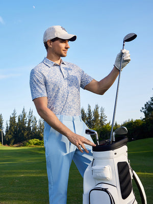 Model taking club from golf bag on course wearing Popular heather print polo in cyan massif