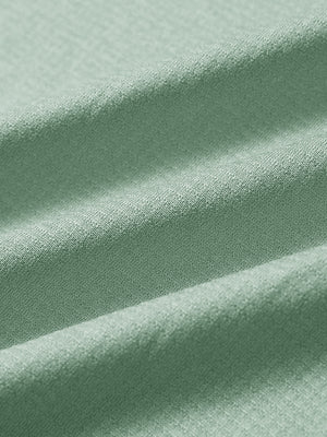 Close-up of beryl green melange moisture wicking quarter zip pullover fabric texture